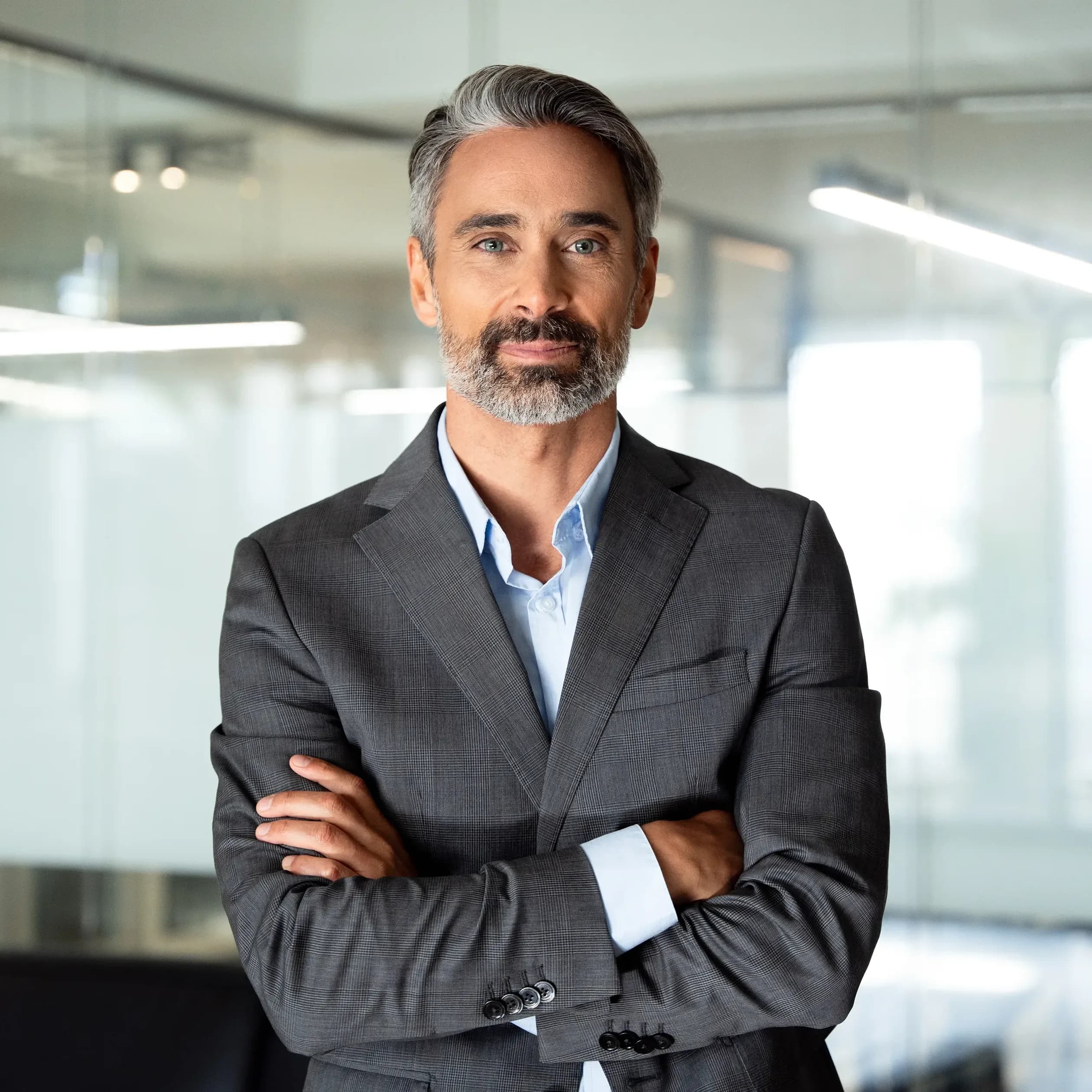 Portrait of a handsome middle-aged Chief Information Officer with a grey sports coat and arms crossed