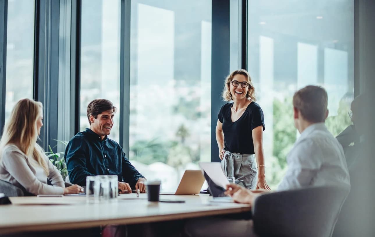 A general counsel enjoys a meeting with her department about the progress they’ve made in automating their corporate legal operations.