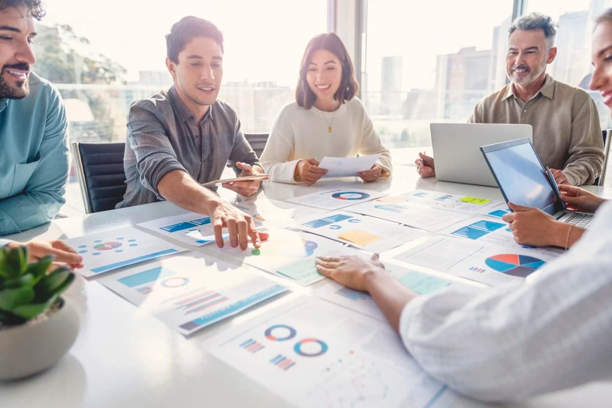 Members of a legal team meet with their company’s stakeholders to review their data processing agreements and discuss regulatory compliance.