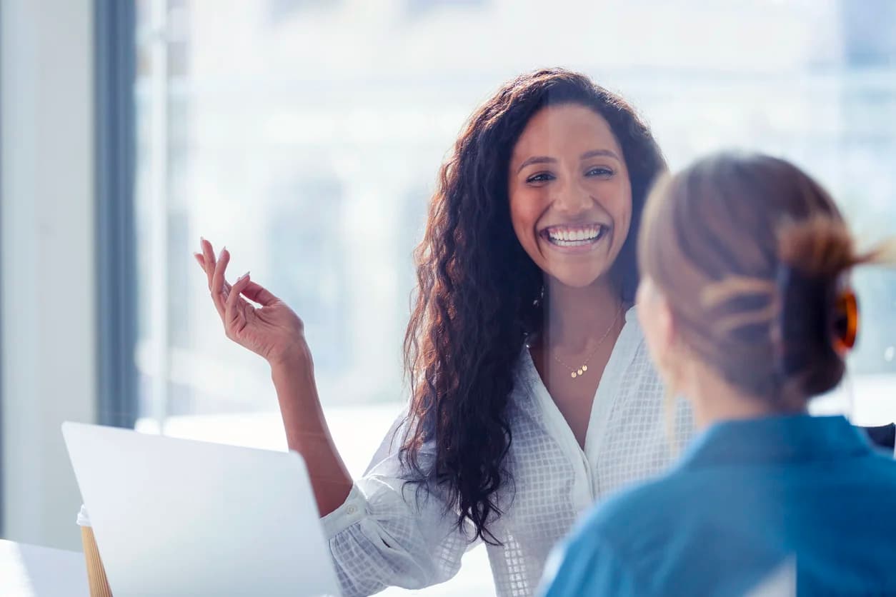 The general counsel at a corporate legal department enjoys the insights from her legal operations consulting meeting with an experienced professional.