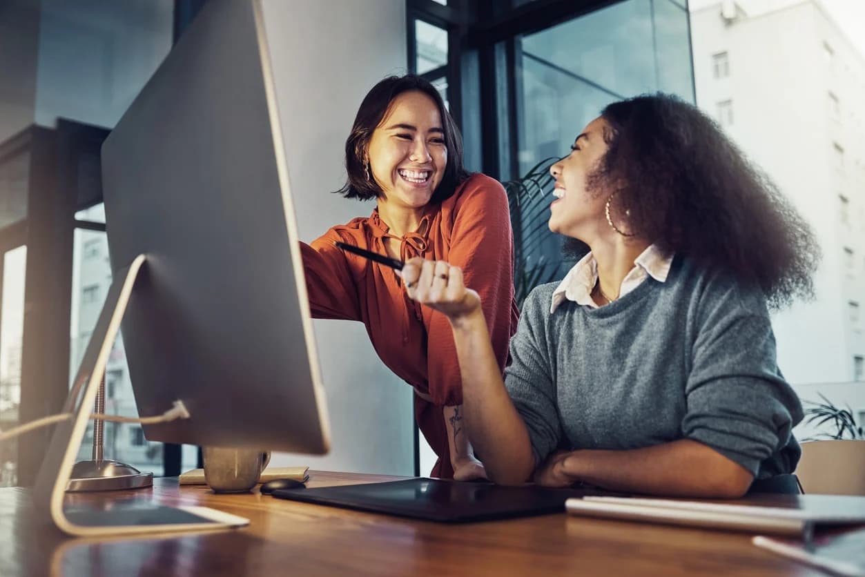 Businesswomen collaborating on a corporate project, emphasizing the importance of knowledge management in a legal setting.