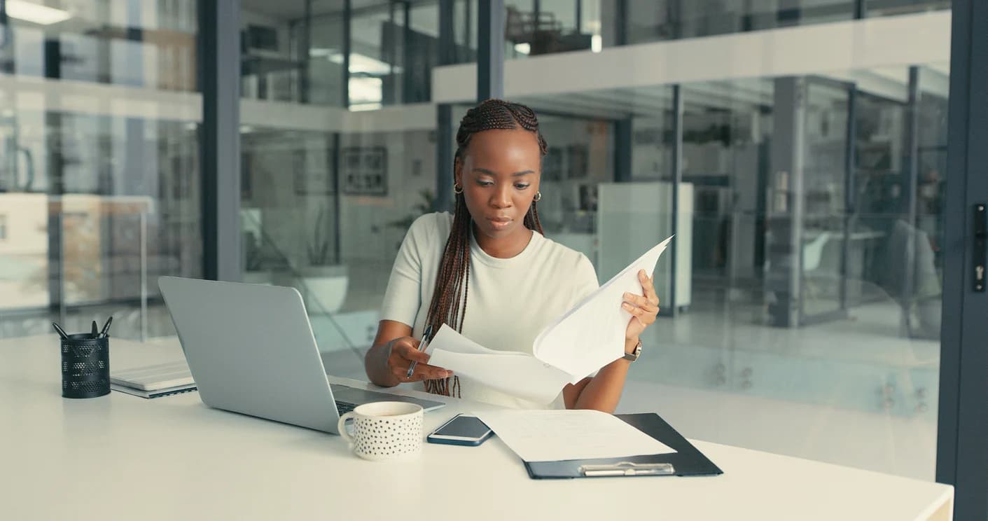 Woman performs document review services within a modern office environment.